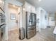 Bright kitchen area featuring stainless steel refrigerator, appliances, eat-in dining area, and wood flooring at 18743 Coastal Shore Ter, Land O Lakes, FL 34638