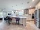 Modern kitchen island with seating, stainless steel appliances, and an open view to the living space at 18743 Coastal Shore Ter, Land O Lakes, FL 34638