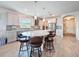 Bright kitchen featuring a large island with seating, pendant lights, and stainless steel appliances at 18743 Coastal Shore Ter, Land O Lakes, FL 34638