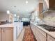 Spacious kitchen with an island that overlooks the breakfast nook and living room at 18743 Coastal Shore Ter, Land O Lakes, FL 34638