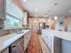 Modern kitchen showcasing stainless steel appliances, a large window, and stylish countertops at 18743 Coastal Shore Ter, Land O Lakes, FL 34638