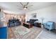 Spacious living room with comfortable seating, a ceiling fan, and a view into the adjacent dining area at 18743 Coastal Shore Ter, Land O Lakes, FL 34638
