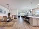 Open-concept living space featuring a dining area, kitchen island with seating, and a cozy living room at 18743 Coastal Shore Ter, Land O Lakes, FL 34638
