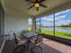 Enjoy tranquil water views from this screened-in patio with ceiling fan and outdoor dining set at 18743 Coastal Shore Ter, Land O Lakes, FL 34638