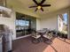 Relax and dine on this covered patio with outdoor kitchen, ceiling fan, and sliding glass doors at 18743 Coastal Shore Ter, Land O Lakes, FL 34638