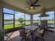Entertain effortlessly on the screened-in patio with ceiling fan, dining set, and built-in grill at 18743 Coastal Shore Ter, Land O Lakes, FL 34638
