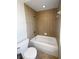 Cozy bathroom with tiled shower and white fixtures at 4249 Hawksley Pl, Wesley Chapel, FL 33545
