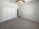 Neutral bedroom with a ceiling fan and closet with folding doors at 4249 Hawksley Pl, Wesley Chapel, FL 33545