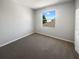 Cozy bedroom with neutral carpet and a bright window providing natural light at 4249 Hawksley Pl, Wesley Chapel, FL 33545