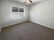 Bedroom features carpet flooring, a ceiling fan, and a window providing ample sunlight at 4249 Hawksley Pl, Wesley Chapel, FL 33545