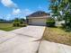Inviting home boasts a convenient two-car garage, and classic landscaping, offering a warm, suburban feel at 4249 Hawksley Pl, Wesley Chapel, FL 33545