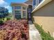 Two-story home exterior with garden bed and a pathway leading to the front door at 4249 Hawksley Pl, Wesley Chapel, FL 33545