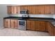Kitchen with stainless steel appliances, wooden cabinets, and countertops at 4249 Hawksley Pl, Wesley Chapel, FL 33545