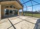 Screened lanai showcases view into the fenced yard and sliding glass doors to interior at 4249 Hawksley Pl, Wesley Chapel, FL 33545