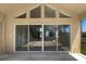 Large sliding glass doors in the living room lead to a spacious screened lanai with views at 4249 Hawksley Pl, Wesley Chapel, FL 33545