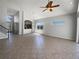 Bright, open living space features tile flooring, archway, and staircase at 4249 Hawksley Pl, Wesley Chapel, FL 33545
