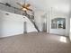 Spacious living room with high ceilings, tile flooring, and a staircase leading to the second floor at 4249 Hawksley Pl, Wesley Chapel, FL 33545