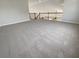 Carpeted loft space with a railing overlooking the living area below at 4249 Hawksley Pl, Wesley Chapel, FL 33545