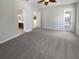 Open main bedroom features carpet flooring with view to the ensuite bath at 4249 Hawksley Pl, Wesley Chapel, FL 33545