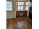 Sun-filled dining area featuring hardwood floors, bay window with built in storage, and door to patio at 12627 W Cherrydale Ln, Hudson, FL 34669