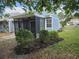Well-maintained home featuring a screened-in porch and beautiful landscaping at 12627 W Cherrydale Ln, Hudson, FL 34669