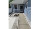 The front door is surrounded by decorative stone and concrete pavers with a tiled entryway at 12627 W Cherrydale Ln, Hudson, FL 34669
