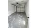 An empty garage with a sealed concrete floor at 12627 W Cherrydale Ln, Hudson, FL 34669