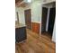 Hallway with wood flooring and wood-paneled walls and a set of closet doors at 12627 W Cherrydale Ln, Hudson, FL 34669
