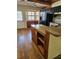 Bright kitchen with wood floors, a breakfast bar, and a built-in desk at 12627 W Cherrydale Ln, Hudson, FL 34669