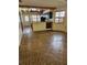 Open-concept living area with wood floors leading into the kitchen at 12627 W Cherrydale Ln, Hudson, FL 34669