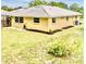 Exterior of the home showcasing the backyard with a newer white tile roof at 201 Chardin Dr, Nokomis, FL 34275