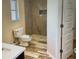 Bathroom featuring a tiled walk-in shower, tile floors, and modern fixtures for a spa-like experience at 201 Chardin Dr, Nokomis, FL 34275