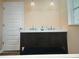 Bathroom featuring a double vanity with dark wood cabinets and white countertop, complemented by modern lighting fixtures at 201 Chardin Dr, Nokomis, FL 34275
