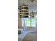 Modern dining area featuring unique pendant lighting and an exterior view at 201 Chardin Dr, Nokomis, FL 34275