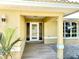 Welcoming entryway with stylish tile flooring and modern glass paneled door at 201 Chardin Dr, Nokomis, FL 34275