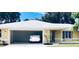 Inviting home with a spacious garage, crisp white trim, and verdant landscaping at 201 Chardin Dr, Nokomis, FL 34275