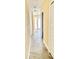 Hallway with tile floors leading to bright rooms through white doors, offering a clean and inviting space at 201 Chardin Dr, Nokomis, FL 34275