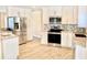 Updated kitchen features stainless steel appliances, granite counters, and ample storage at 201 Chardin Dr, Nokomis, FL 34275