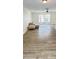 Bright living room featuring wood-look tile floors, neutral-colored walls, and a large window with natural light at 201 Chardin Dr, Nokomis, FL 34275
