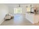 Bright, open-concept living space with a breakfast bar and modern stainless steel refrigerator at 201 Chardin Dr, Nokomis, FL 34275