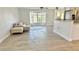 Bright living room featuring wood-look tile floors, neutral-colored walls, and a large window with natural light at 201 Chardin Dr, Nokomis, FL 34275