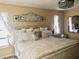 Main bedroom features a decorative headboard and chandelier lighting at 201 Chardin Dr, Nokomis, FL 34275