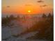 A picturesque beach sunset with people enjoying the scenery at 201 Chardin Dr, Nokomis, FL 34275