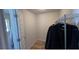 Walk-in closet with a hanging rack for clothes, offering ample storage space with a clean, organized layout at 201 Chardin Dr, Nokomis, FL 34275