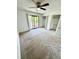 Spacious bedroom featuring a ceiling fan, neutral carpet, and sliding glass doors to the patio at 22620 Gage Loop # 25, Land O Lakes, FL 34639