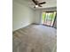 Bedroom with ceiling fan, neutral carpet, and sliding glass doors to an outdoor patio at 22620 Gage Loop # 25, Land O Lakes, FL 34639