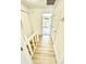 Upstairs hallway featuring wood flooring, white doors, and natural light at 22620 Gage Loop # 25, Land O Lakes, FL 34639
