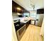 Well-lit kitchen featuring stainless steel appliances, granite countertops, and dark wood cabinetry at 22620 Gage Loop # 25, Land O Lakes, FL 34639