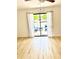 Living space with wood-look flooring and sliding glass doors at 22620 Gage Loop # 25, Land O Lakes, FL 34639