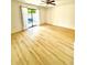 Spacious living room with wood-look flooring and sliding glass doors to patio at 22620 Gage Loop # 25, Land O Lakes, FL 34639
